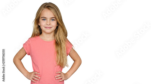 Confident young Caucasian girl posing with hands on hips in pink shirt
