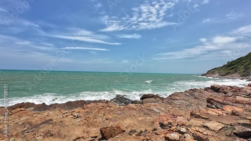 Strong summer winds whip the ocean waves against the rocks.