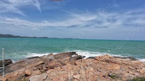 Strong summer winds whip the ocean waves against the rocks.