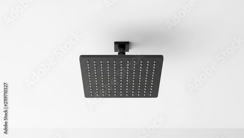 Black square shower head mounted on a white ceiling