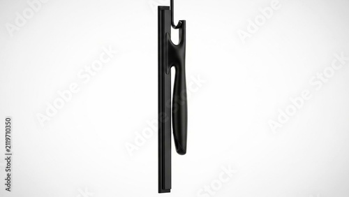 Black window squeegee hanging on a simple wall hook