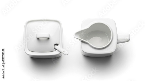 White ceramic sugar bowl and creamer jug on white background
