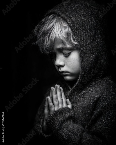 Child praying in peaceful spiritual moment with soft light atmosphere. Ai Generative