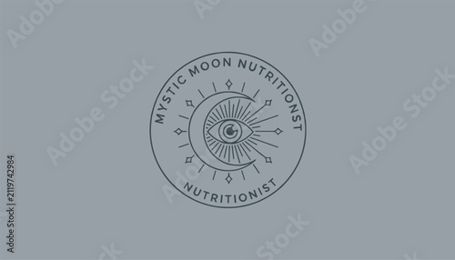 Mystic moon nutritionist logo design showing a mystic eye cradled by a crescent moon on a blue slate background.
