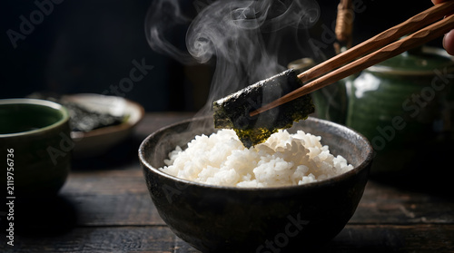 Steaming hot white rice bowl with nori | Traditional Japanese breakfast food photography | Cinematic food shot with wooden chopsticks and steam | Authentic Asian cuisine styling on dark wood