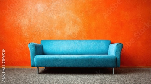 Turquoise sofa against orange wall modern interior decor composition