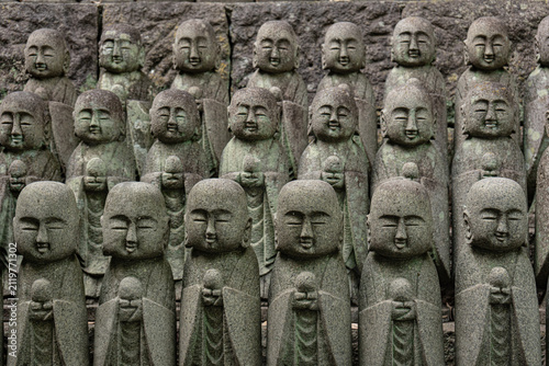 Rows of Jizo stone statues at a Buddhist temple in Japan