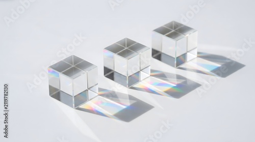 Transparent glass cubes with rainbow light reflections on white background