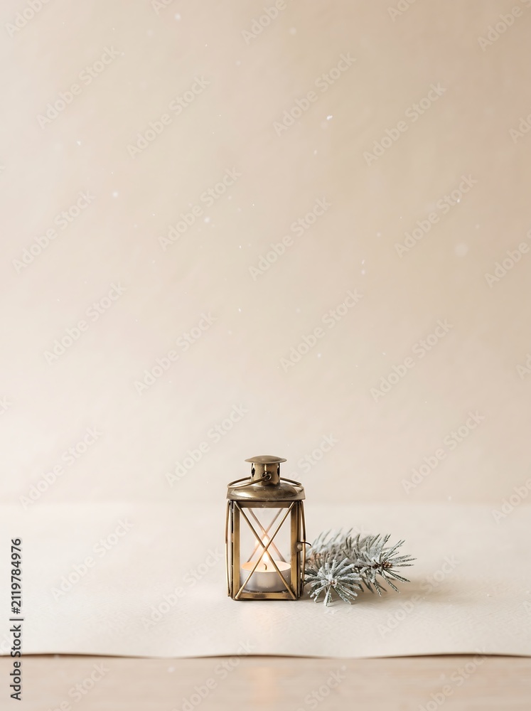 Obraz premium Scandinavian Minimal Christmas Background with Cozy Winter Lantern, Pine Branches and Copy Space