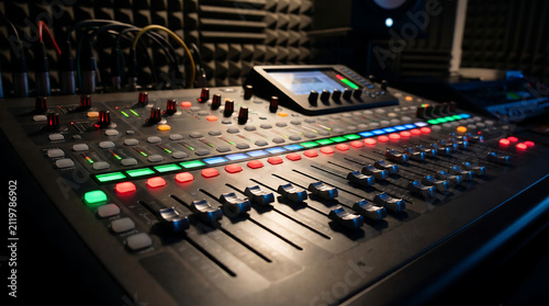 Mixing console with glowing sliders and buttons in studio setting Generative AI