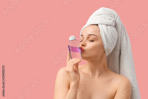 Young woman kissing bottle ...