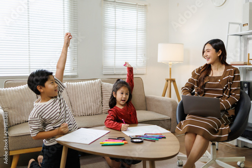 Принти на полотні Asian mother homeschooling two children, a boy and a girl, during remote learnin