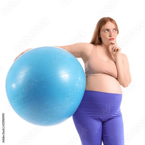 Thoughtful sporty pregnant woman with fitball on white background