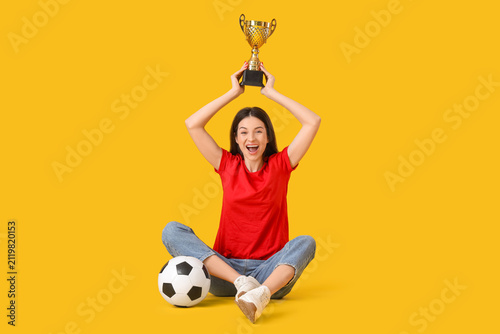 Happy young woman with socc...