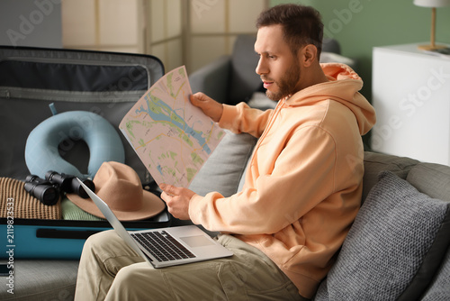 Young male tourist with map...