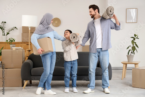 Happy Muslim family carryin...