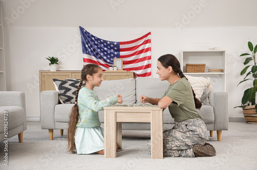 Female soldier with her dau...