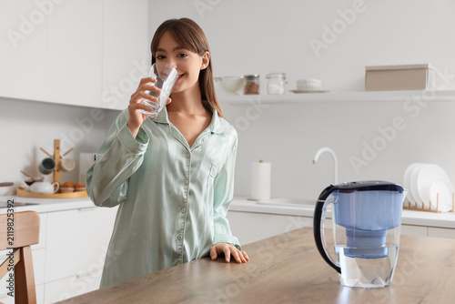 Young woman drinking water ...