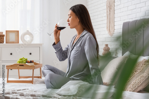 Young Asian woman drinking ...