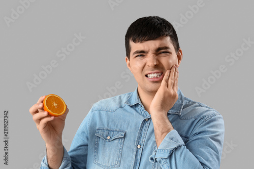Young man with orange suffe...