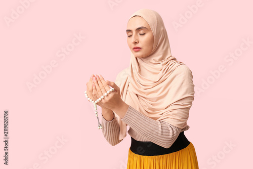 Young Muslim woman with bea...