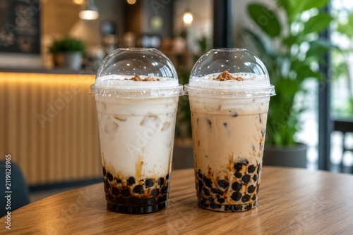 Fresh Milk and Milk Tea with Brown Sugar Tapioca Pearls in Plastic Cup on Wooden Background