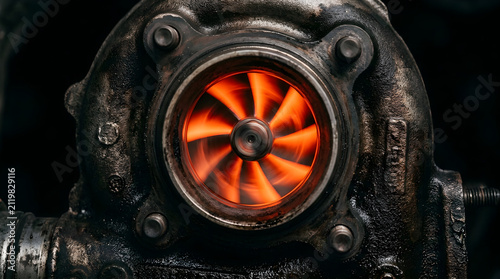 Glowing hot turbine impeller inside a heavy-duty industrial engine part, showcasing extreme heat and mechanical power