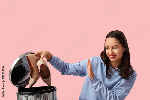 Happy young woman throwing ...