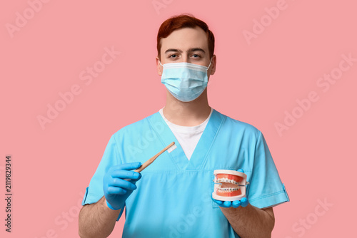 Male dentist in mask with t...