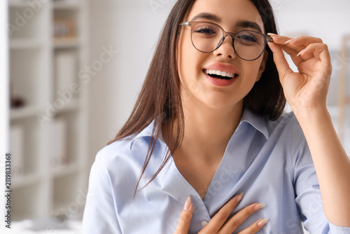 Beautiful young woman wearing glasses in office