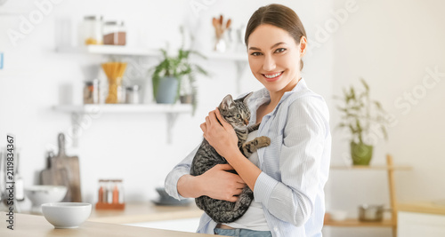 Smiling young woman holding...