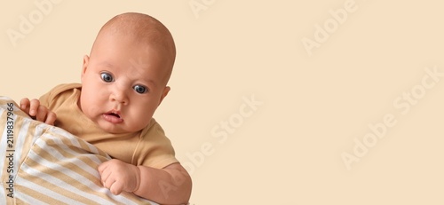 Photography Curious newborn baby with wide eyes peeking from striped blanket, childhood deve