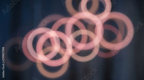 Pink glowing rings floating on dark background Generative AI