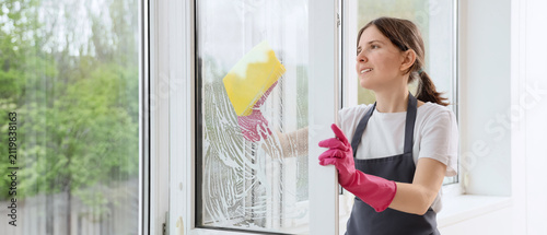 Smiling woman in pink glove...
