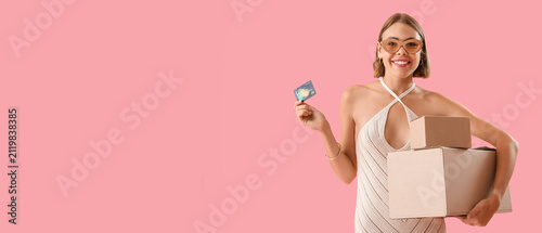 Smiling young woman holding...