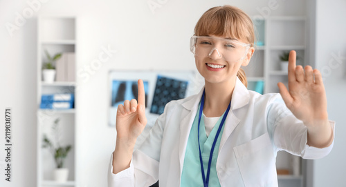 Smiling female doctor in sa...