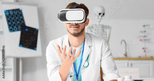 Smiling male doctor wearing...