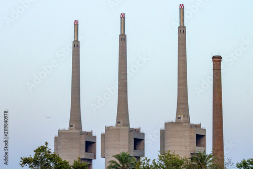 Photography Barcelona, Spain – July 29, 2026: Three concrete smokestacks at former Barcelona