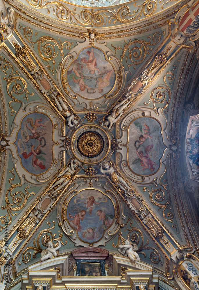 Fototapeta premium MONZA, ITALY - MARCH 19, 2026: The baroque stucco and frescoes of angels on the ceiling of side nave of Cathedral by Carlo Innocenzo Carloni from frist part of 18. cent. 