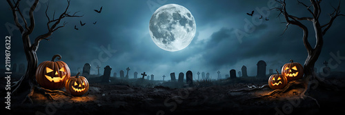 Spooky halloween graveyard scene at night with glowing jack-o-lanterns in the foreground under a large full moon and dark silhouette of tombstones