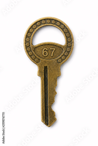 Antique brass key with number 67 isolated
