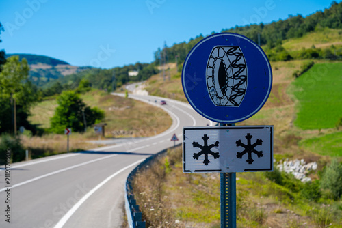 Snow chains mandatory road sign on mountain road