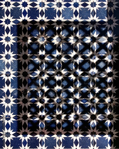 Moorish geometric tile pattern with dramatic light and shadow