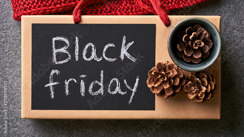 Black Friday chalkboard. Seasonal shopping promotion with pinecones and fabric. Festive composition for retail design  