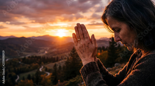 Woman hands praying for blessing from god on sunset background