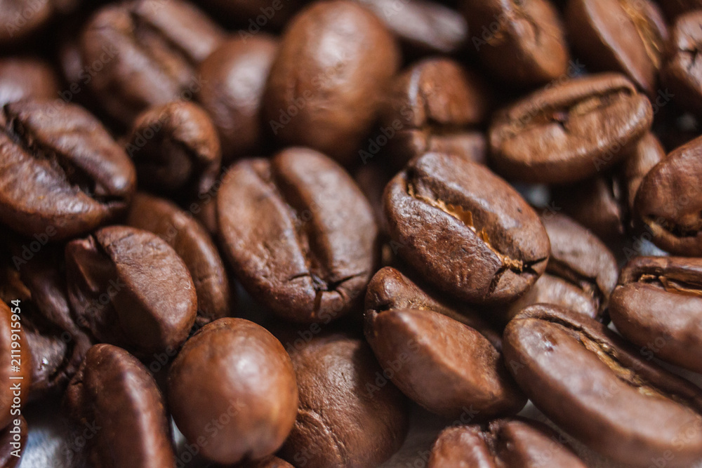 Fototapeta premium Macro Roasted Coffee beans artistic shot photography, brown bean, Arabica, Robusta, Liberica, Excelsa, Kopi Luwak and Black Ivory, freshness aromatic caffeine, selective focus, Cairo Egypt