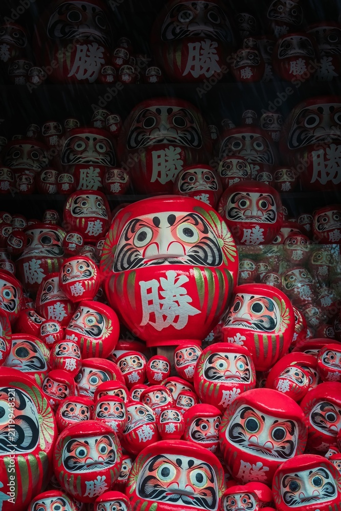 Fototapeta premium Pile of red daruma dolls at Katsuoji temple Osaka Japan traditional good luck charms