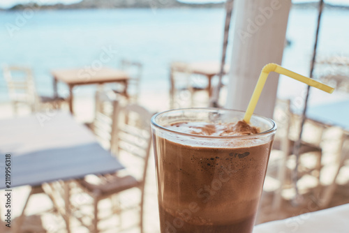 Close-up of a refreshing iced coffee drink in a seaside cafe in Greece