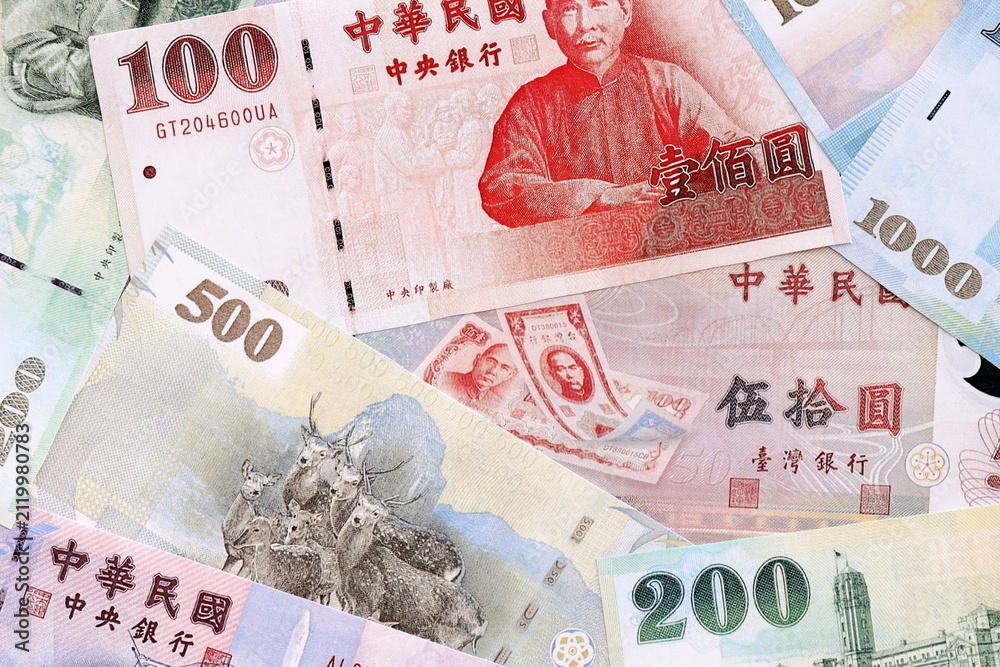 Fototapeta premium Taiwanese dollar money bills pile on table. Taiwan banknotes of TWD currency close up.