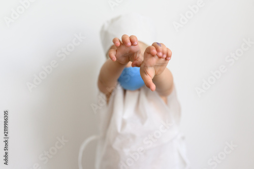 Canvastavla Little child in doctor costume reaching hands forward to camera isolated on whit